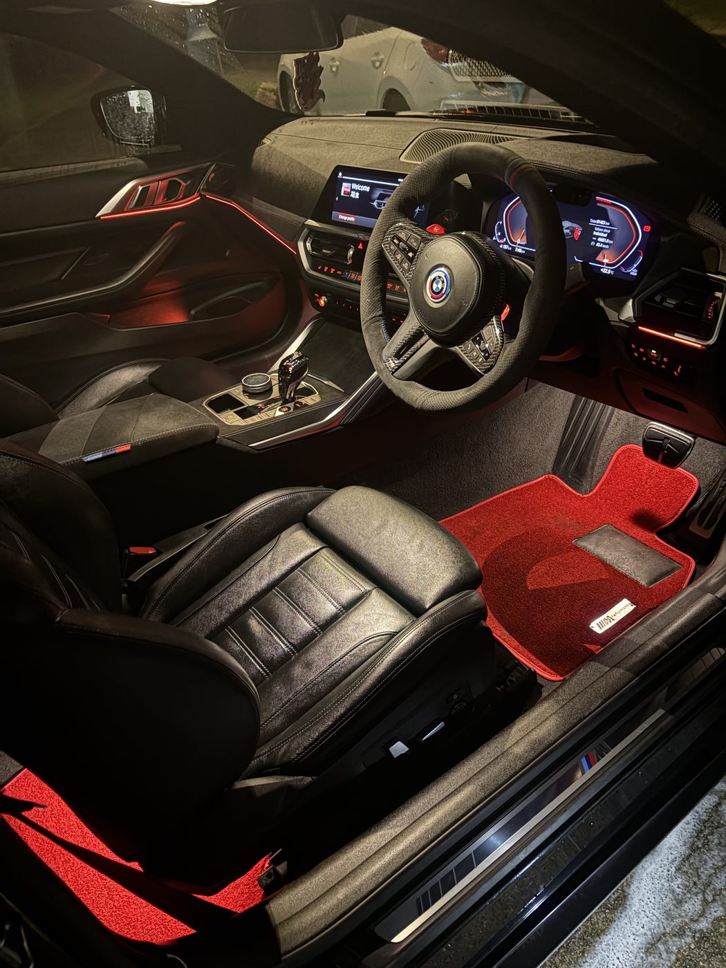 Detailed black BMW interior with red ambient lighting