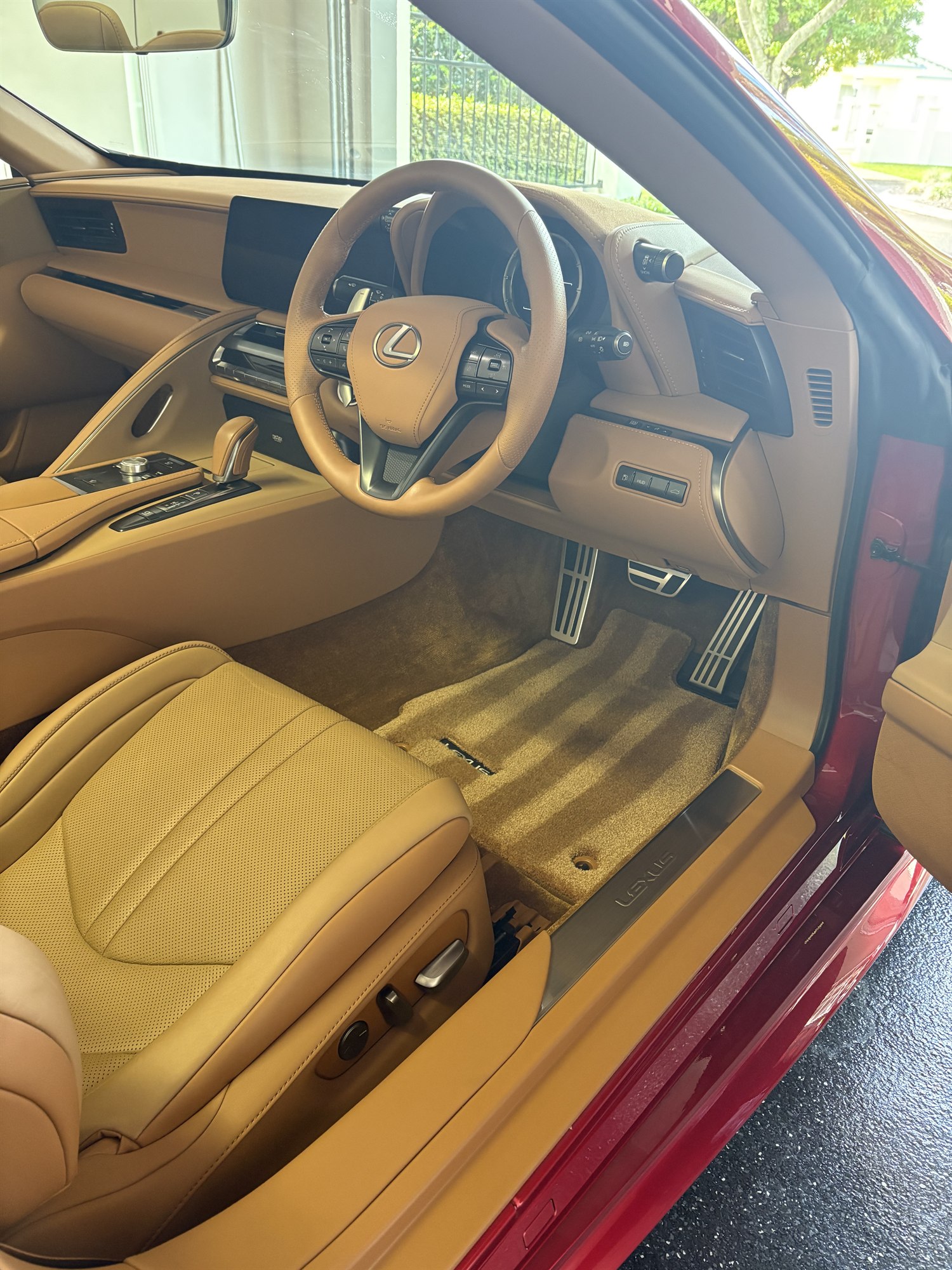 Detailed tan leather interior of a red Lexus LC 500 on the Sunshine Coast