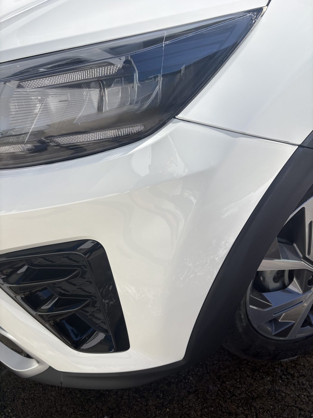 White Kia bumper after light clear coat mark removal